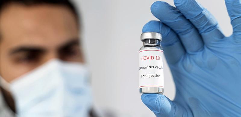 unfocused-doctor-looking-at-vaccine-recipient